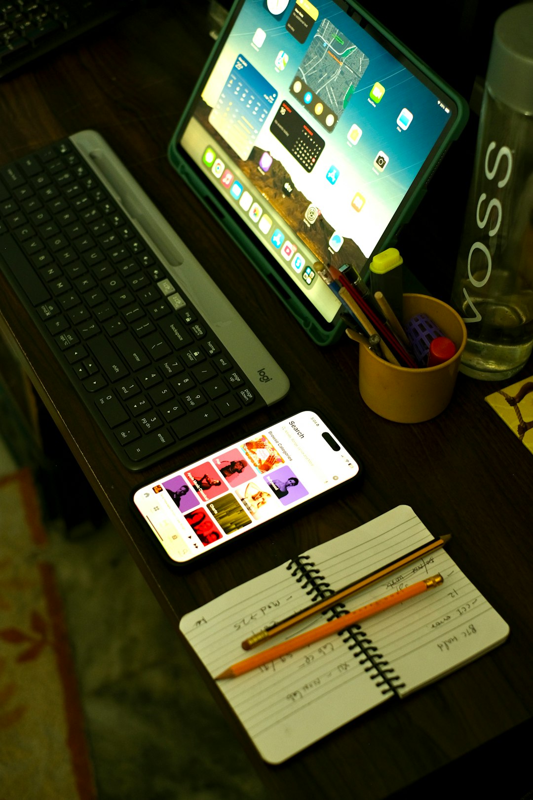 a-desk-with-a-laptop-keyboard-phone-and-a-cup-of-pencils-tvcecywv9fa